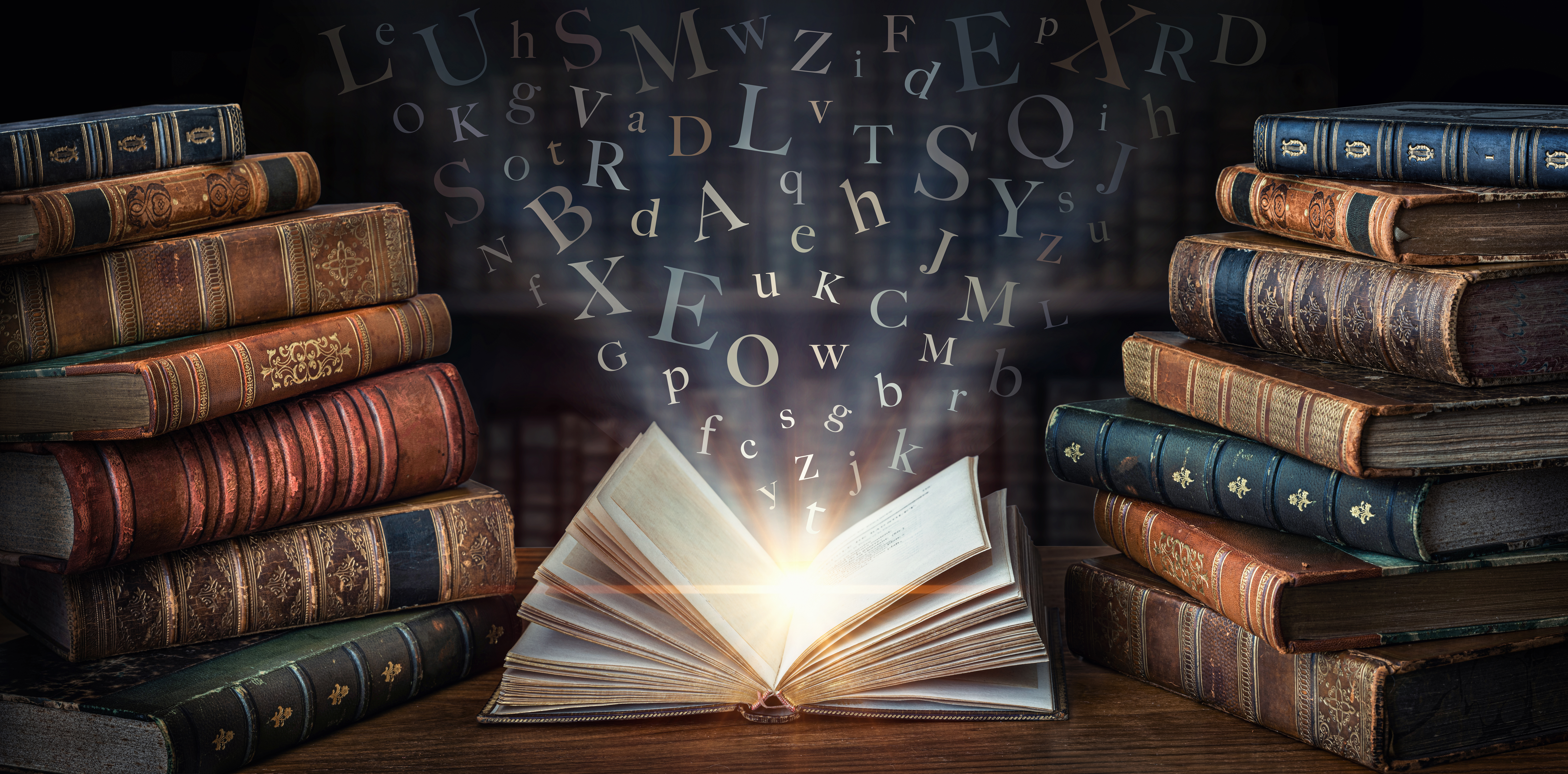 A surreal image of an open book that is glowing with letters flowing out of it