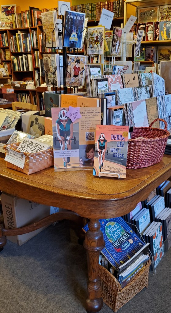 A display of Debra Lee Won't Break with poster advertising the launch party