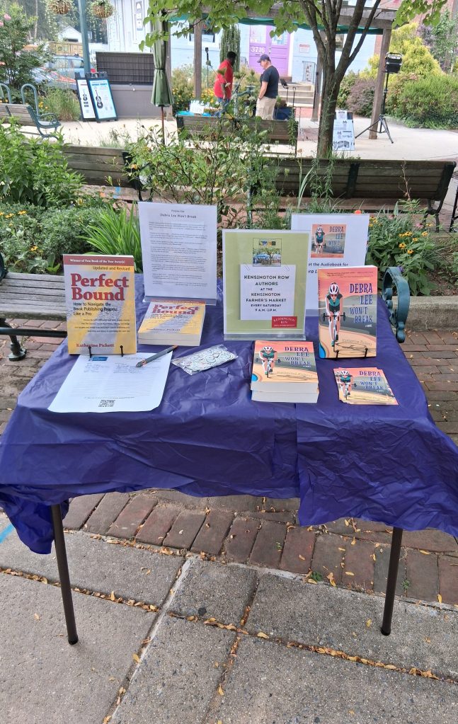 A small table with several books and flyers displayed